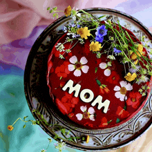 a mother 's day cake with flowers and the word mom on it