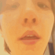 a close up of a person 's face with a pink lip