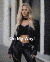 a woman is wearing a black leather jacket and pants and the words on my way are on the bottom