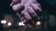 a close up of a person holding hands with a blurry background
