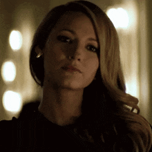 a close up of a woman 's face with a blurry background