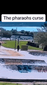 a person is riding a skateboard down a ramp in a park .