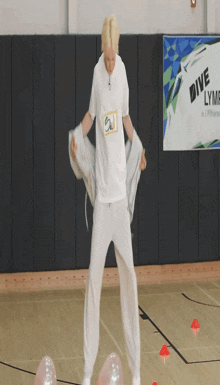 a man standing on a basketball court in front of a sign that says " dive "