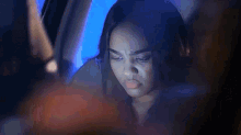 a blurry picture of a woman in a car looking out the window