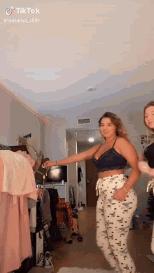 two women are dancing together in a room .