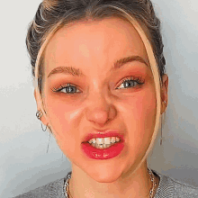 a close up of a woman 's face with her mouth open