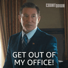 a man in a suit and tie says get out of my office while pointing