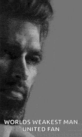 a black and white photo of a man with a beard .