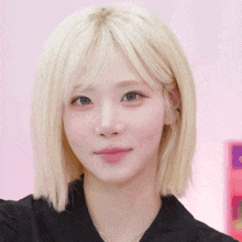 a close up of a woman with blonde hair and blue eyes