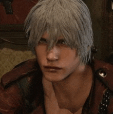a close up of a man 's face with gray hair and a red shirt in a video game .