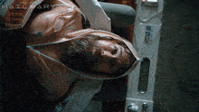 a man with a beard is laying on a bed with the word project hailmary on the bottom right