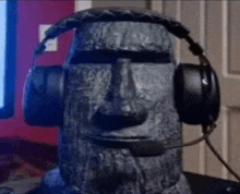a stone statue wearing headphones and a microphone .