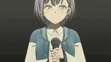 a girl with short hair is holding a microphone in her hands