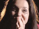 a woman with a bruise on her face covering her mouth with her hands