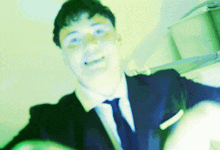 a blurry picture of a man in a suit and tie with his arms outstretched
