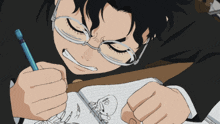 a person wearing glasses is writing on a notebook