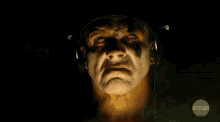 a close up of a man 's face with the axs tv logo on the bottom right