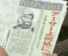 a person is holding a newspaper with chinese writing
