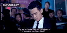 a man in a suit and tie stands in front of a crowd of people .