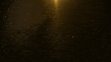 a gold background with a light coming out of the middle