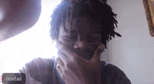 a person covering their mouth with a noxtas icon