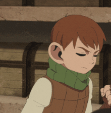 a boy with a green scarf around his neck