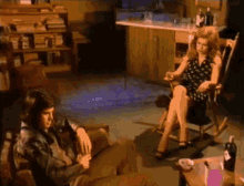 a man and a woman are sitting in rocking chairs in a dark room
