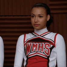 a cheerleader is wearing a uniform that says wmhs on it