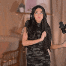 a woman wearing headphones and a camouflage dress