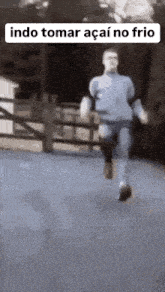 a man with a prosthetic leg is running down a street in a blurry photo .