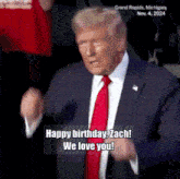 a man in a suit and tie says happy birthday zach