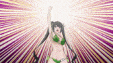 a girl in a green bikini is raising her fist