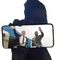 a person is taking a picture of a man in a suit and tie