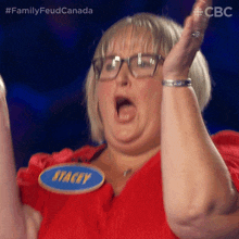 a woman with glasses and a name tag that says stacy on it