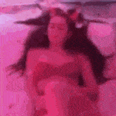 a blurry picture of a woman laying on a bed in a pink bathtub .