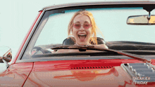 a woman in a red car with freakier friday written on the bottom
