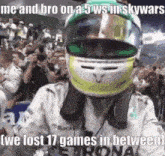 a racing driver wearing a helmet is standing in front of a crowd .