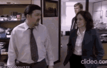 a man in a white shirt and tie is standing next to a woman