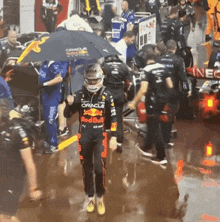 a man in a red bull outfit holds an umbrella over his head