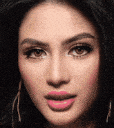 a close up of a woman 's face with pink lips and brown eyes