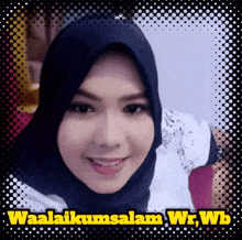 a woman wearing a hijab is smiling in front of a sign that says waalaikumsalam wr wb