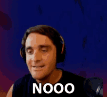a man wearing headphones with the word nooo written on his face