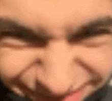a close up of a person making a funny face with their tongue sticking out .