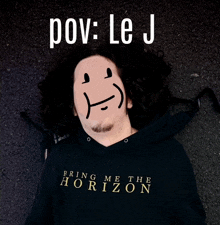 a man wearing a hoodie that says bring me the horizon on it
