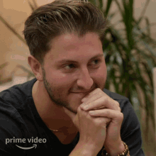 a man with a beard is wearing a black shirt that says prime video on it