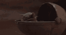 a baby in a stroller is flying through the air in a dark room .