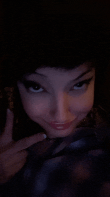 a close up of a woman making a funny face with her finger