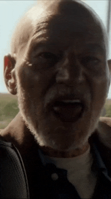 an elderly man with a beard is making a funny face .