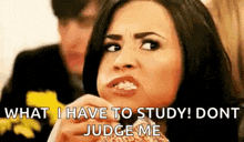 a woman is eating a sandwich and says `` what i have to study ! don 't judge me '' .