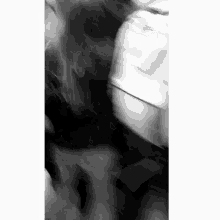 a blurry black and white photo of a person walking